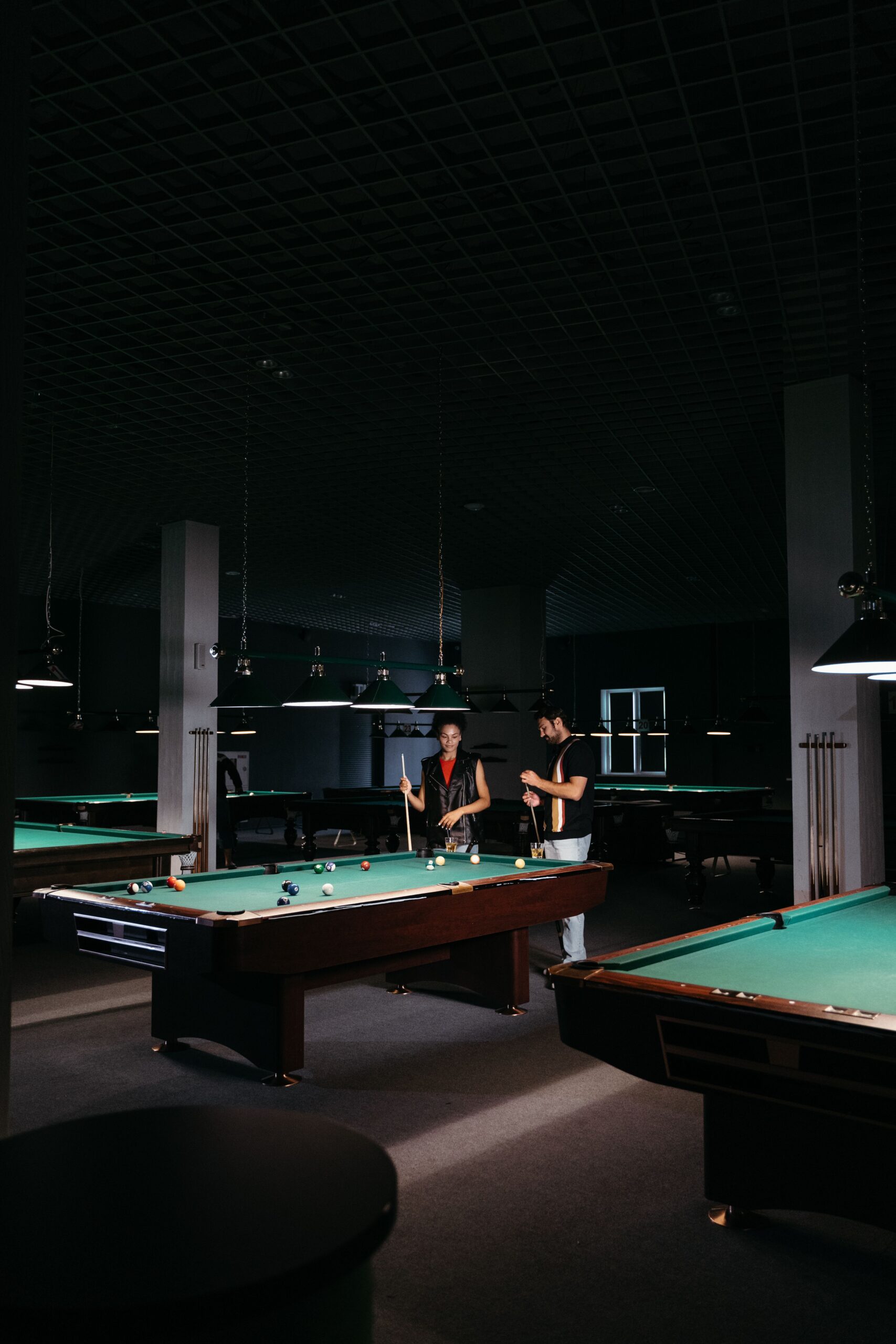 Players enjoying a game of pool in a billiards room